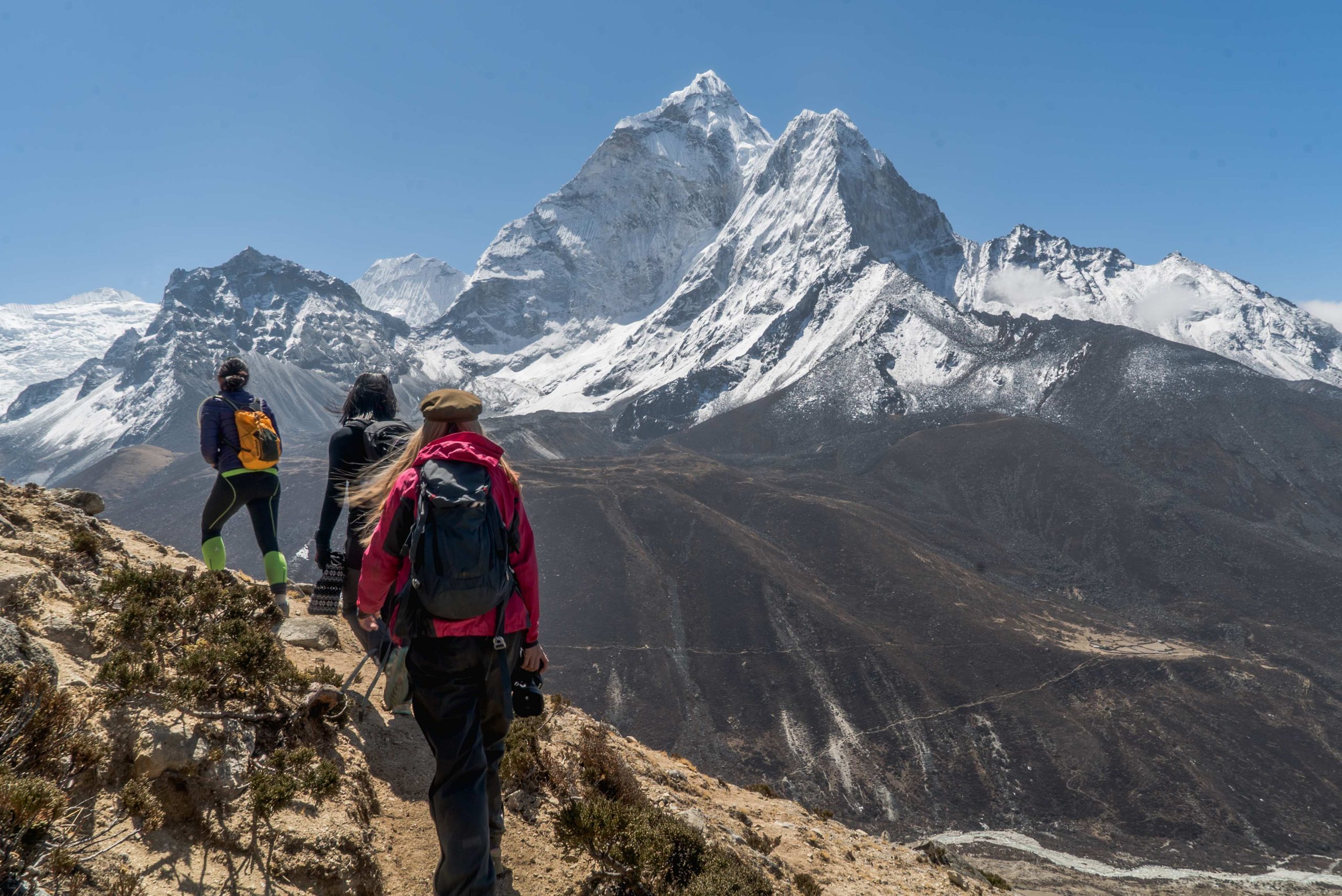 Walkers-on-track-EBC-with-view-of-mounrtain-scaled